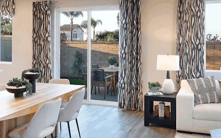 A room with a table chairs and a couch.