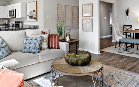 A living room with a couch and a table.