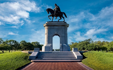 A statue of a person riding a horse on a pedestal.