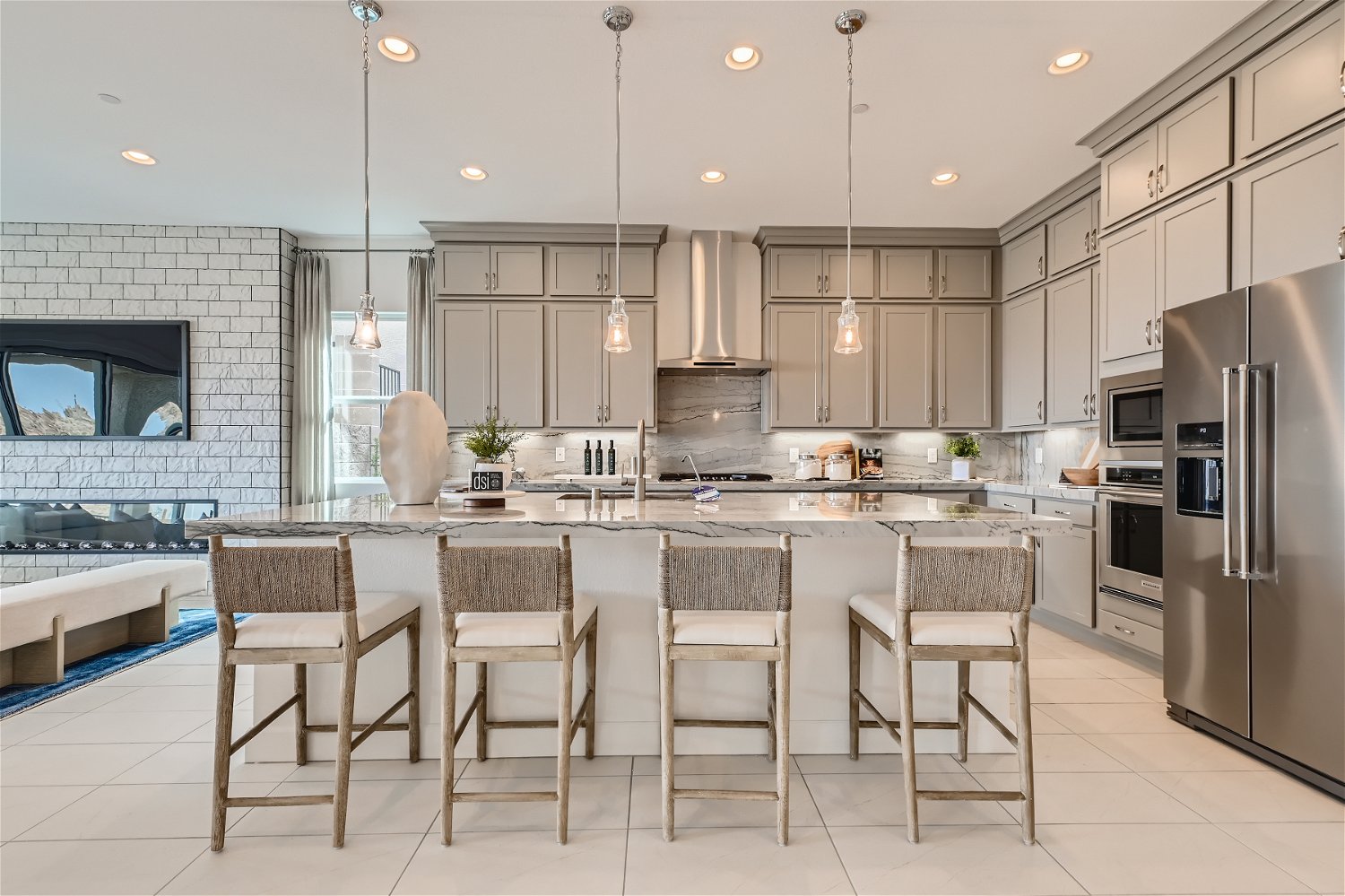 A kitchen with a bar and chairs.