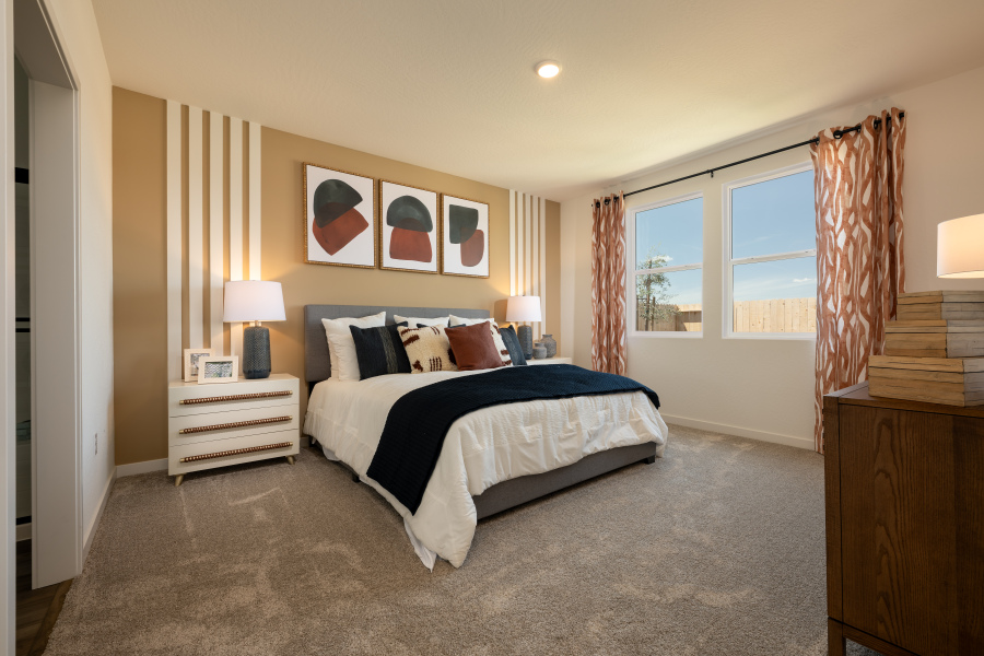 A bedroom with a bed and a window.