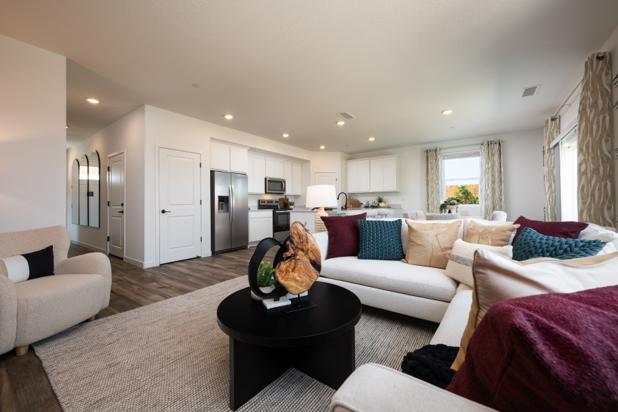 A large living room with a couch and a table.