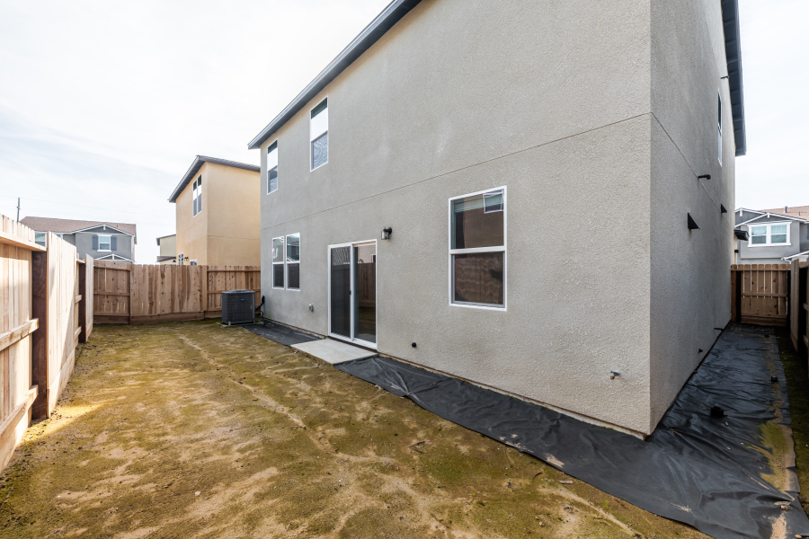 A grey building with a fence around it.