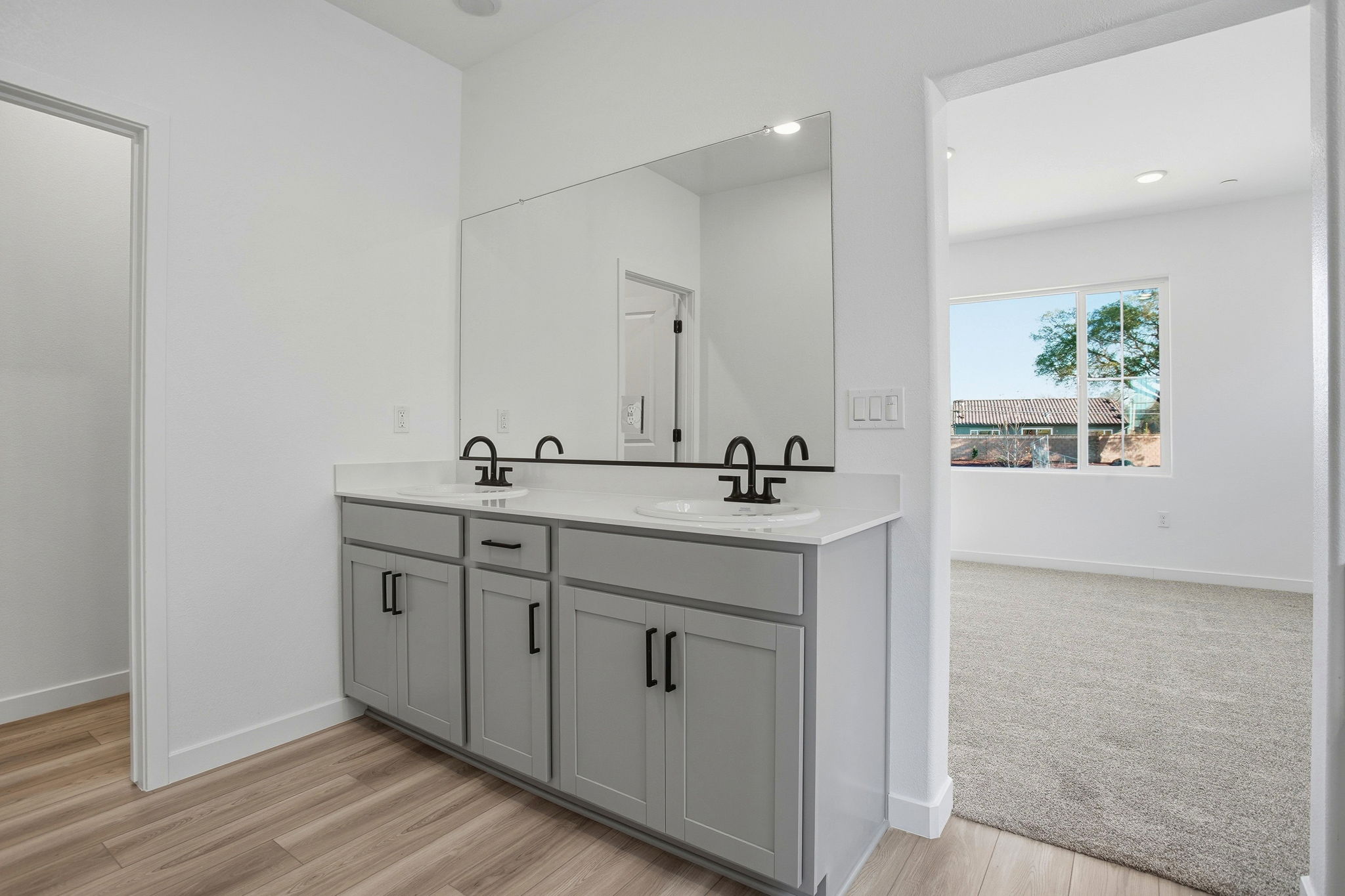 A bathroom with a large mirror.