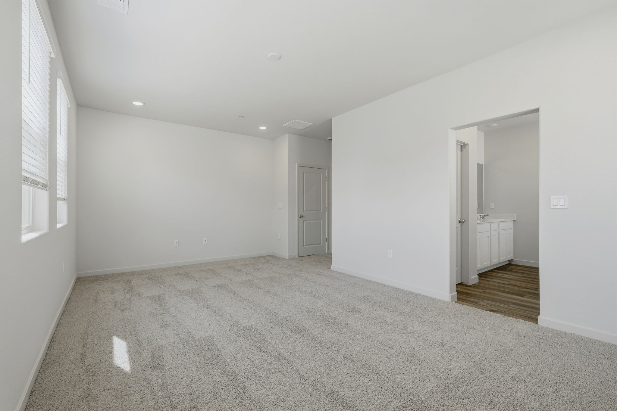 A hallway with white walls.