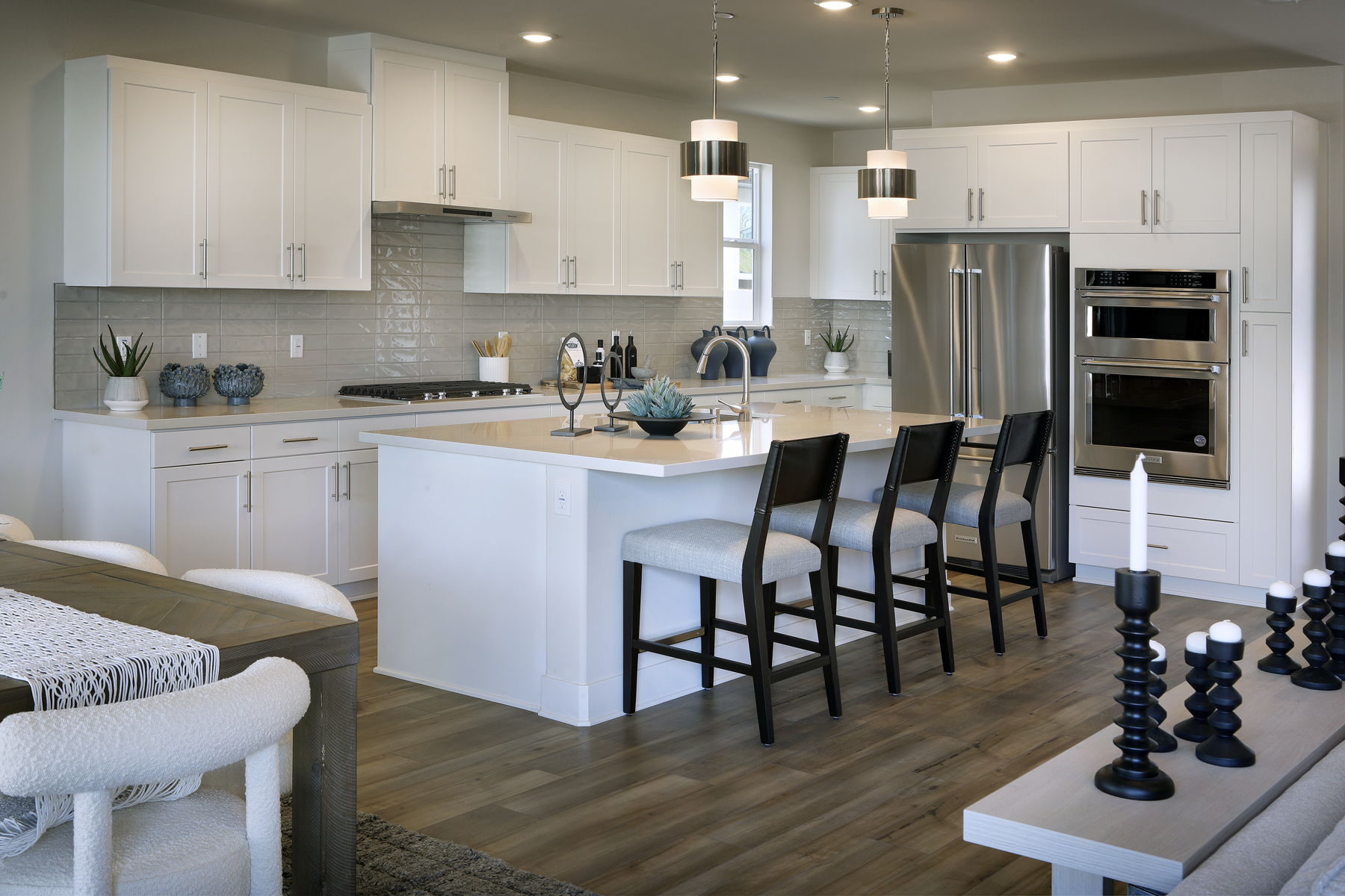 A kitchen with white cabinets.
