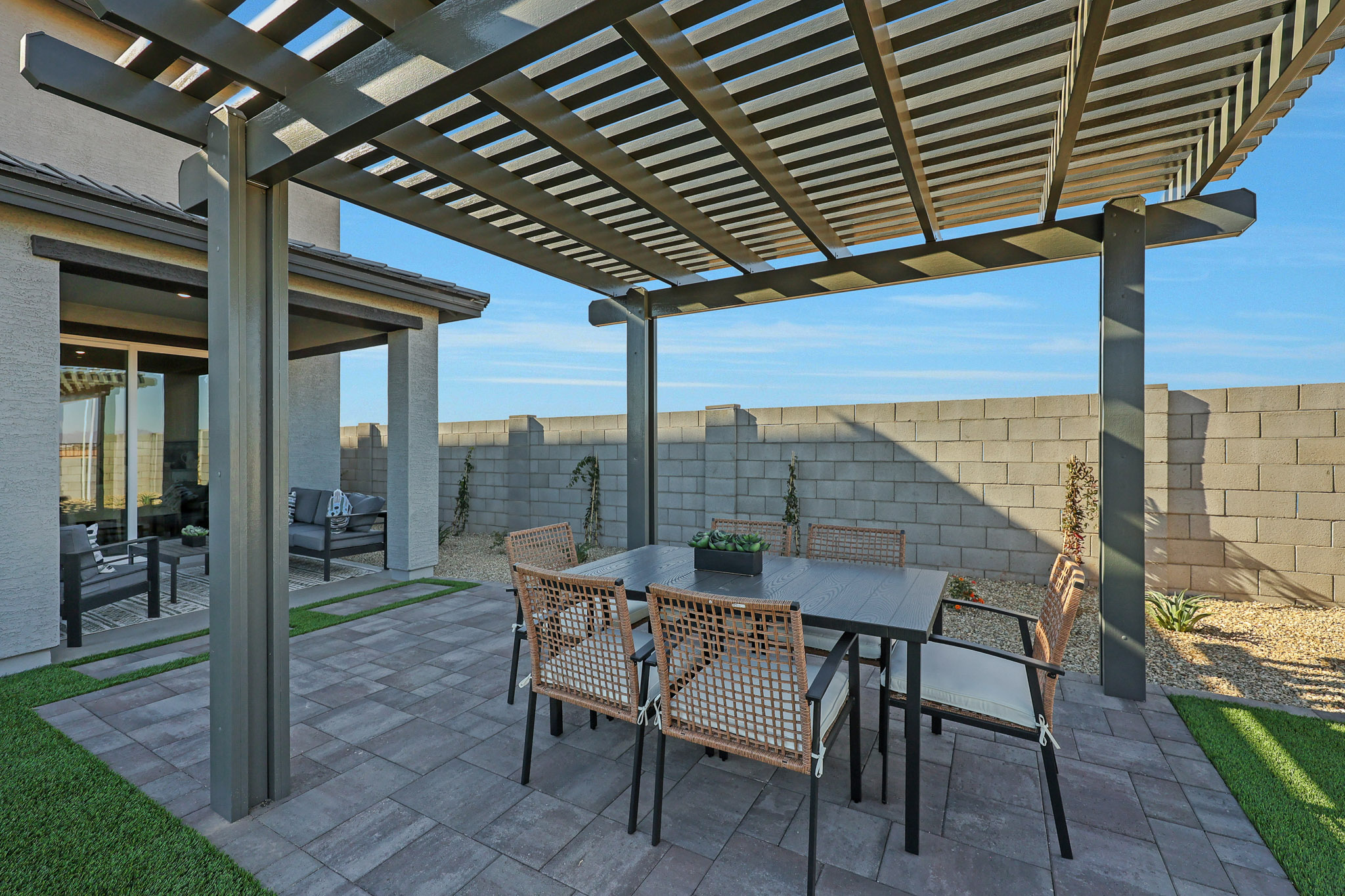 A patio with a table and chairs.