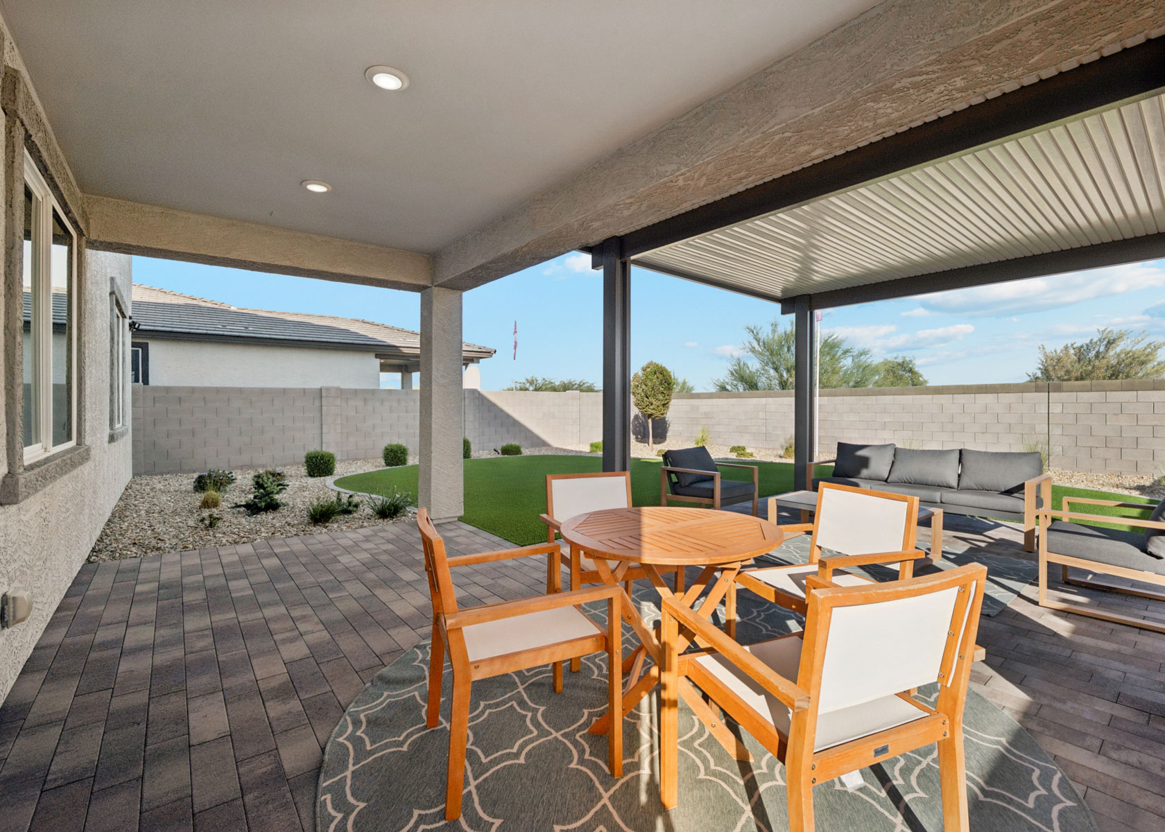 A patio with tables and chairs.