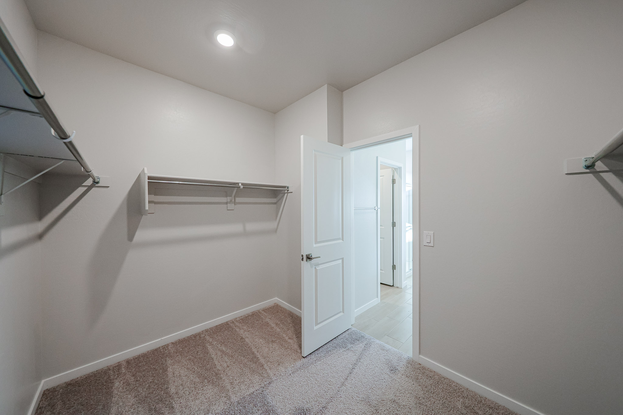 A hallway with white doors.