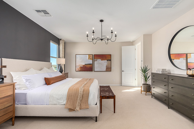 A bedroom with a large mirror.