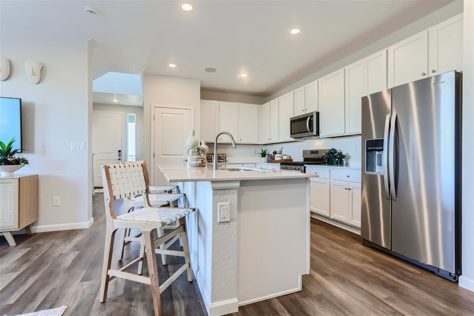 A kitchen with white cabinets.