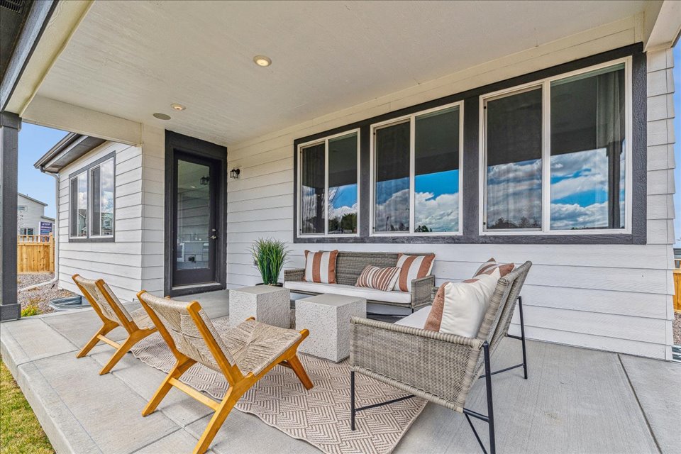 A living room with a patio and a large window.