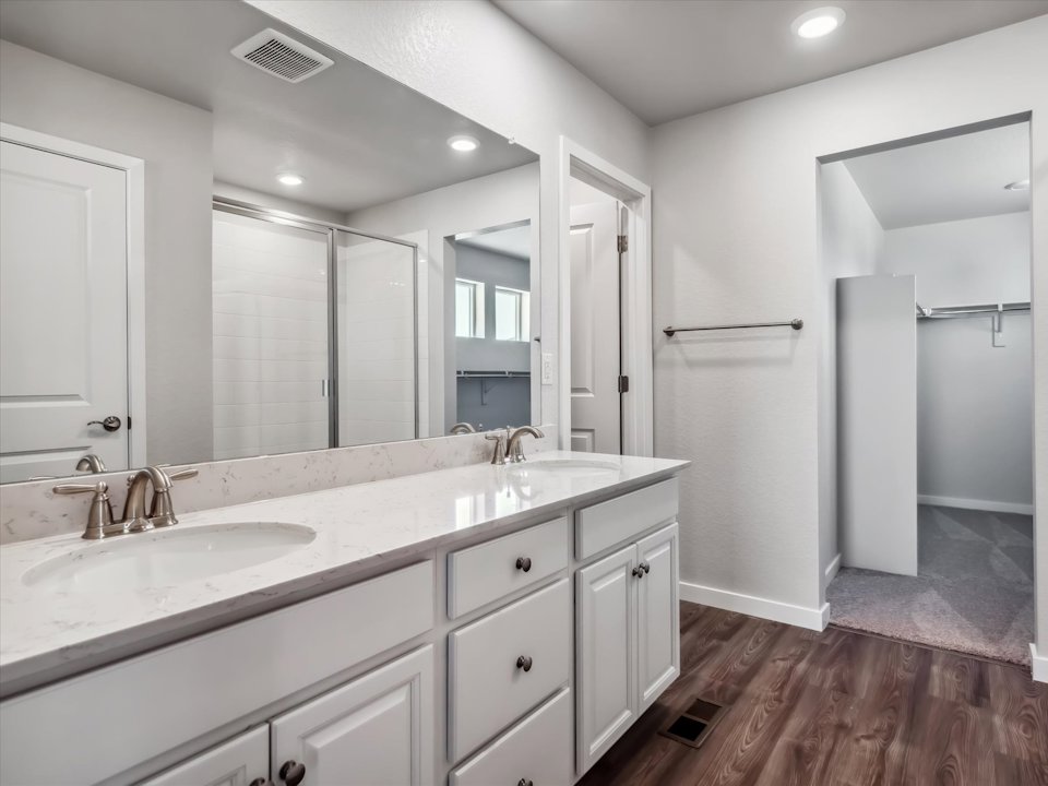 A bathroom with a large mirror.