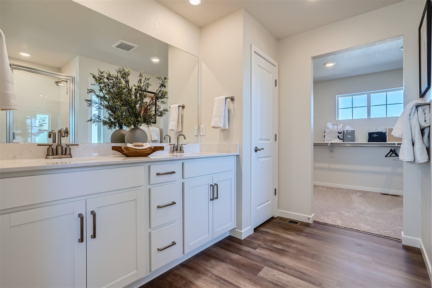 A bathroom with white cabinets.