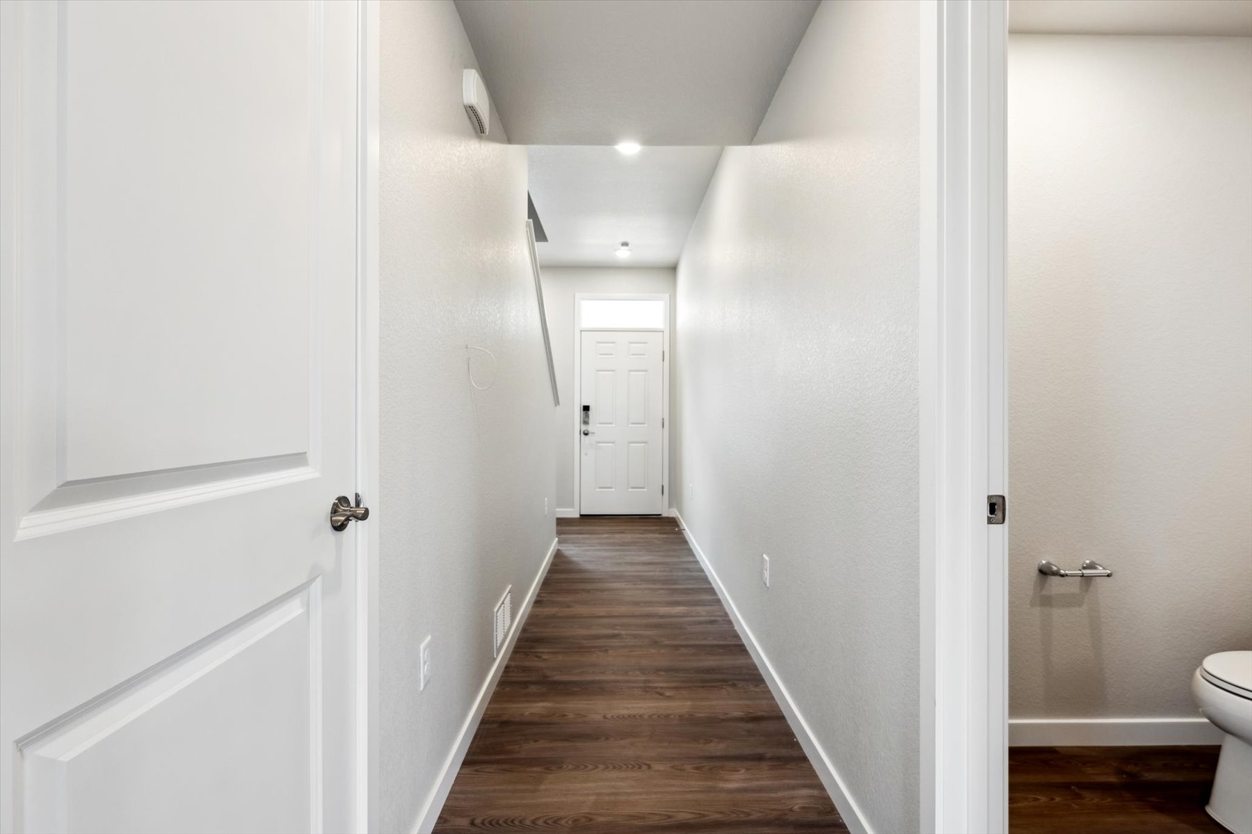 A hallway with white doors.