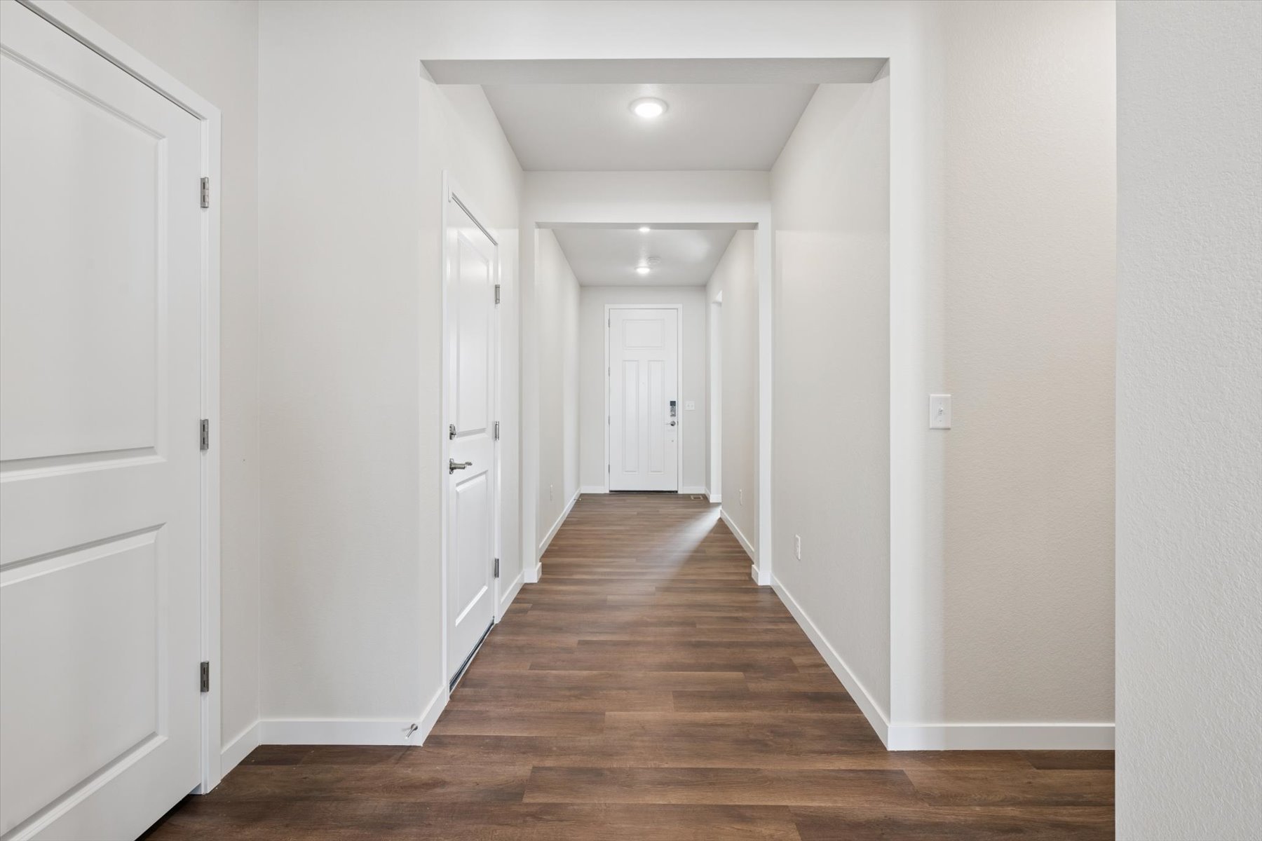 A hallway with white doors.