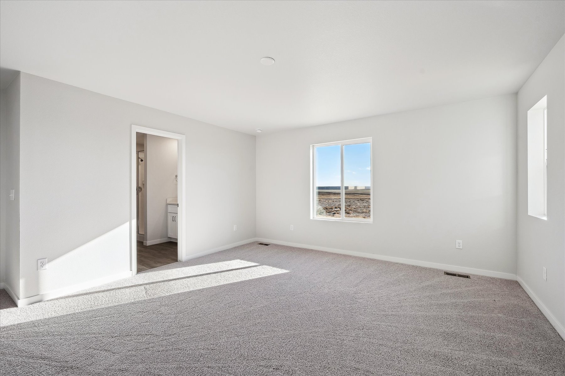 A room with a window and a door.