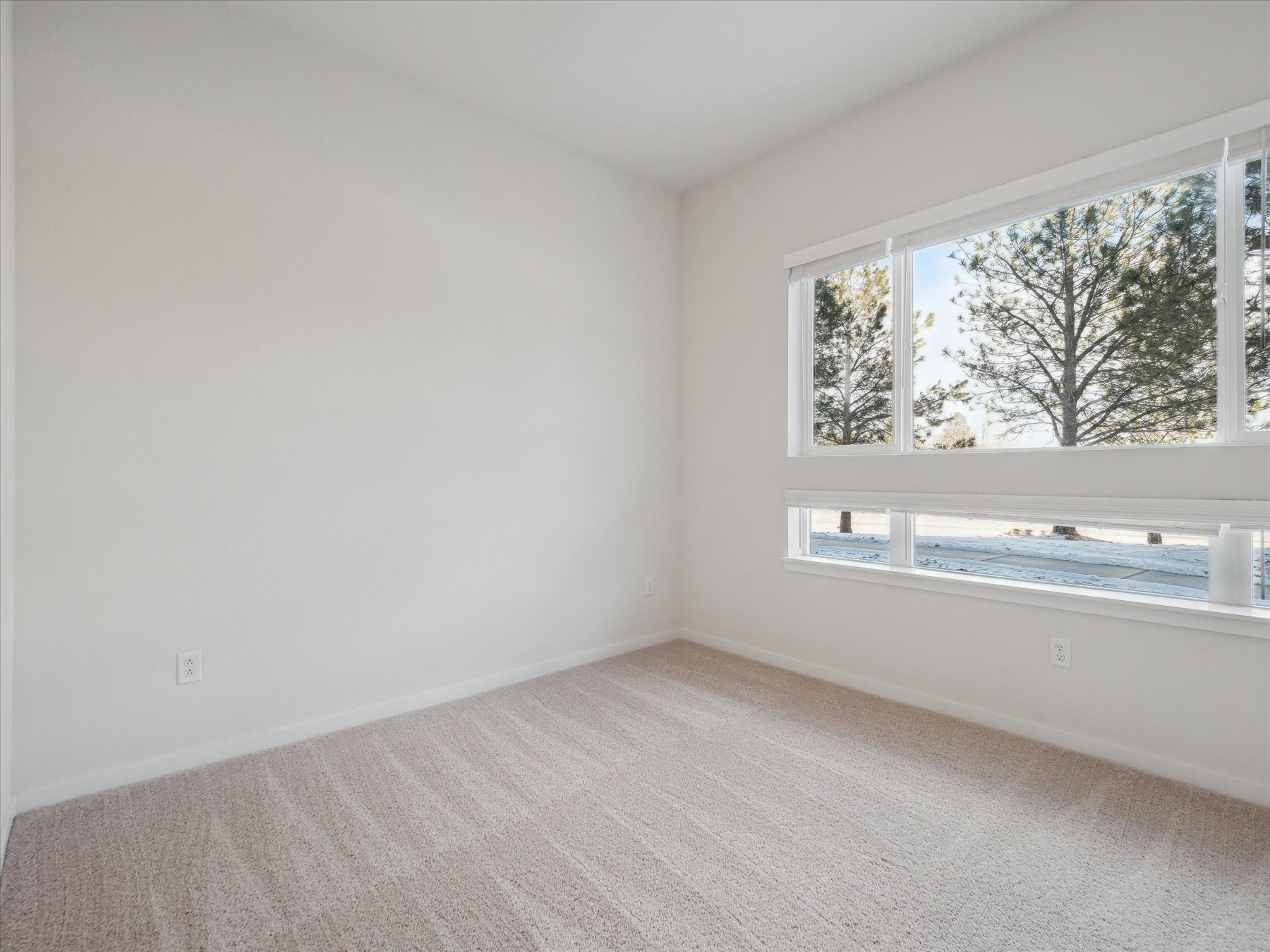 A room with a window and a bathtub.