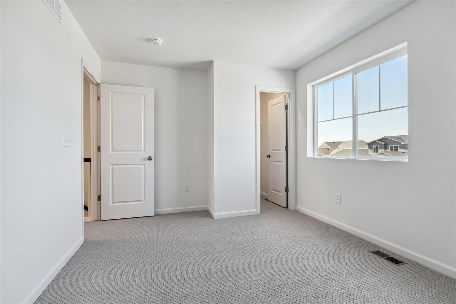 A room with white walls and a window.
