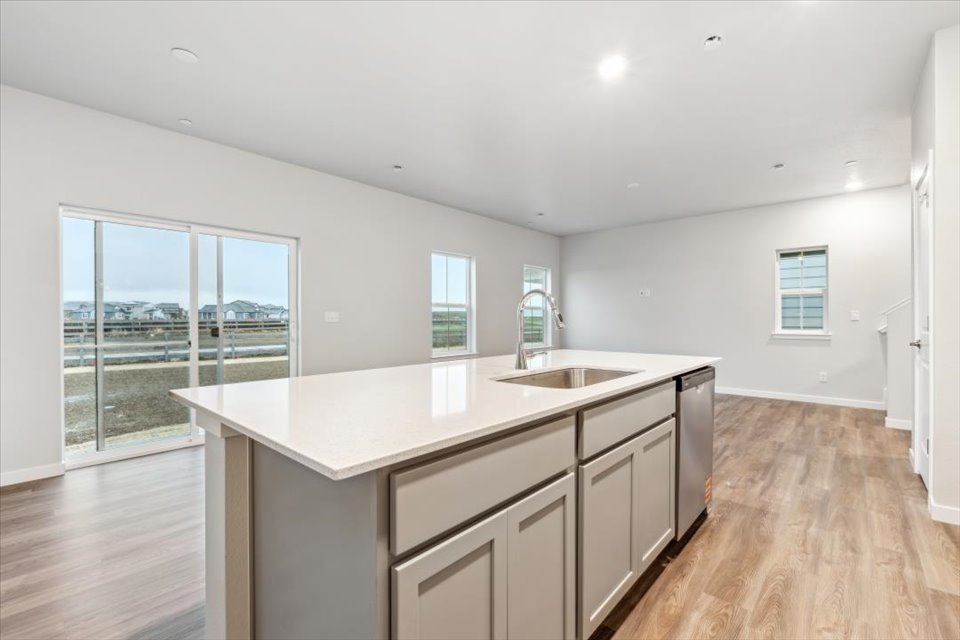 A kitchen with a large window.