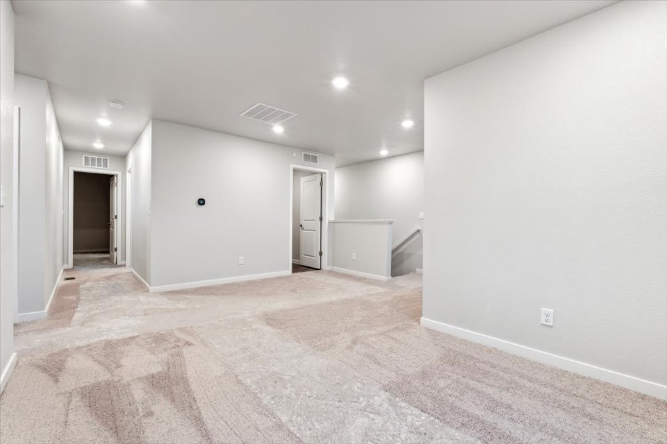 A hallway with white walls.