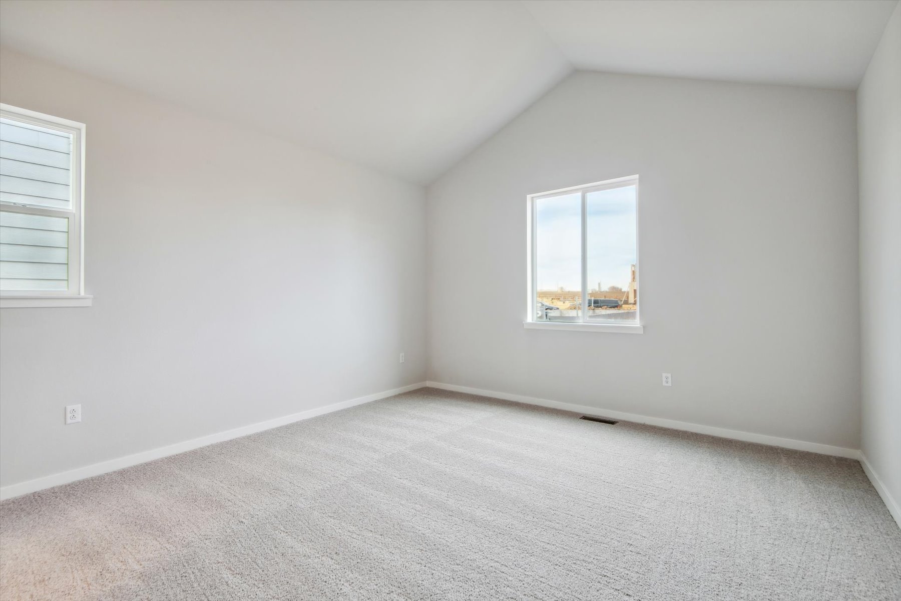 A room with a window and a carpet.