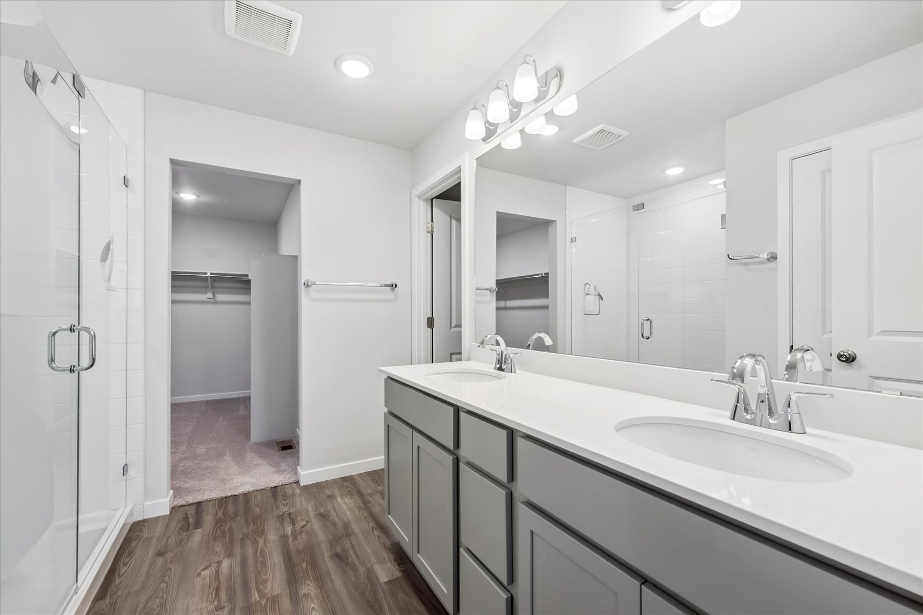 A bathroom with a large mirror.