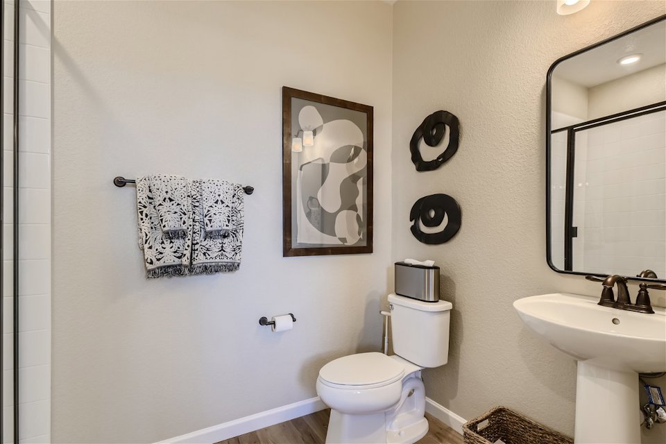 A bathroom with a toilet and a mirror.