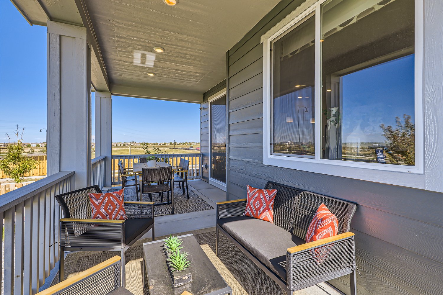 A deck with a couch and chairs.