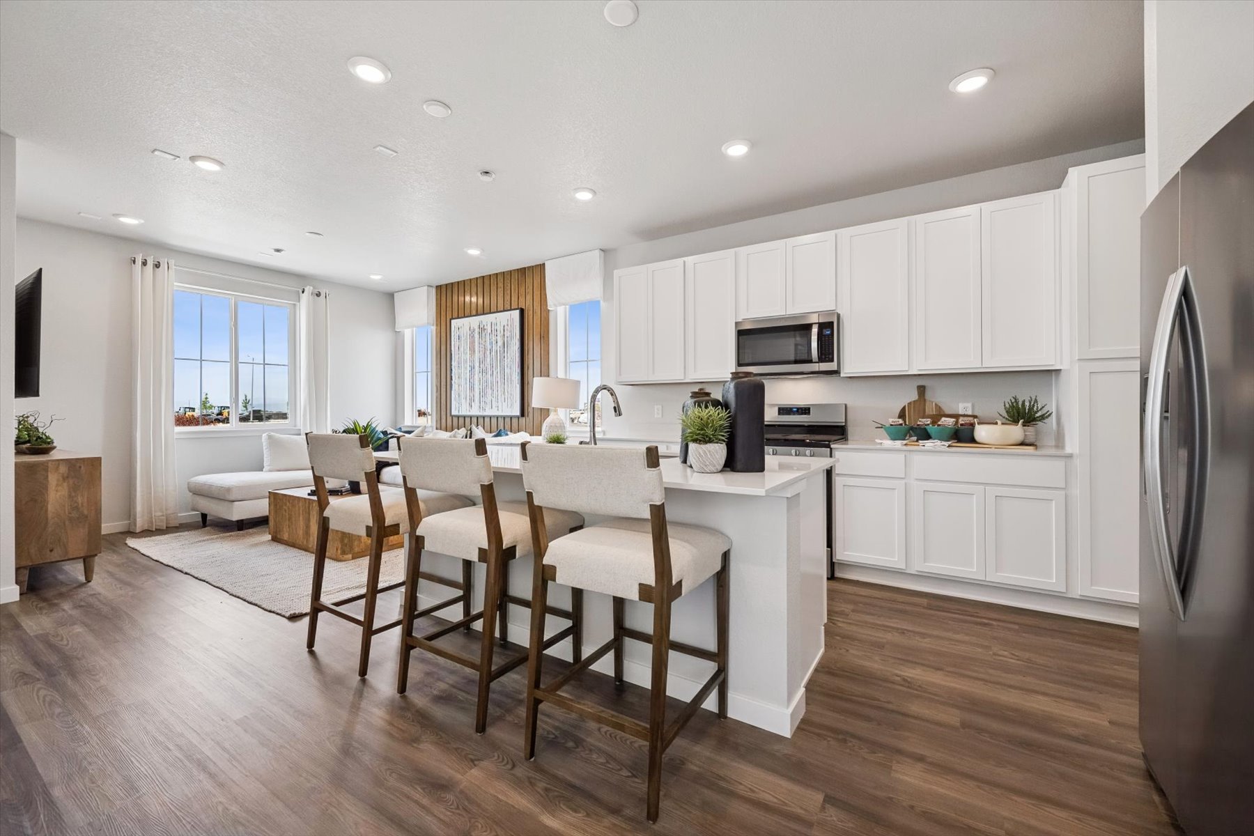 A kitchen with white cabinets.