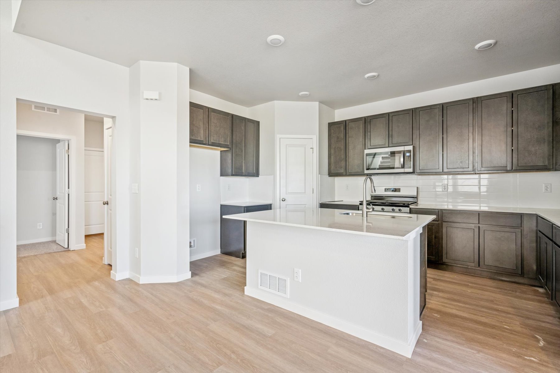 A kitchen with wooden cabinets.