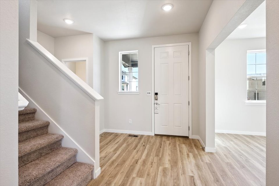 A room with white walls and a wood floor.