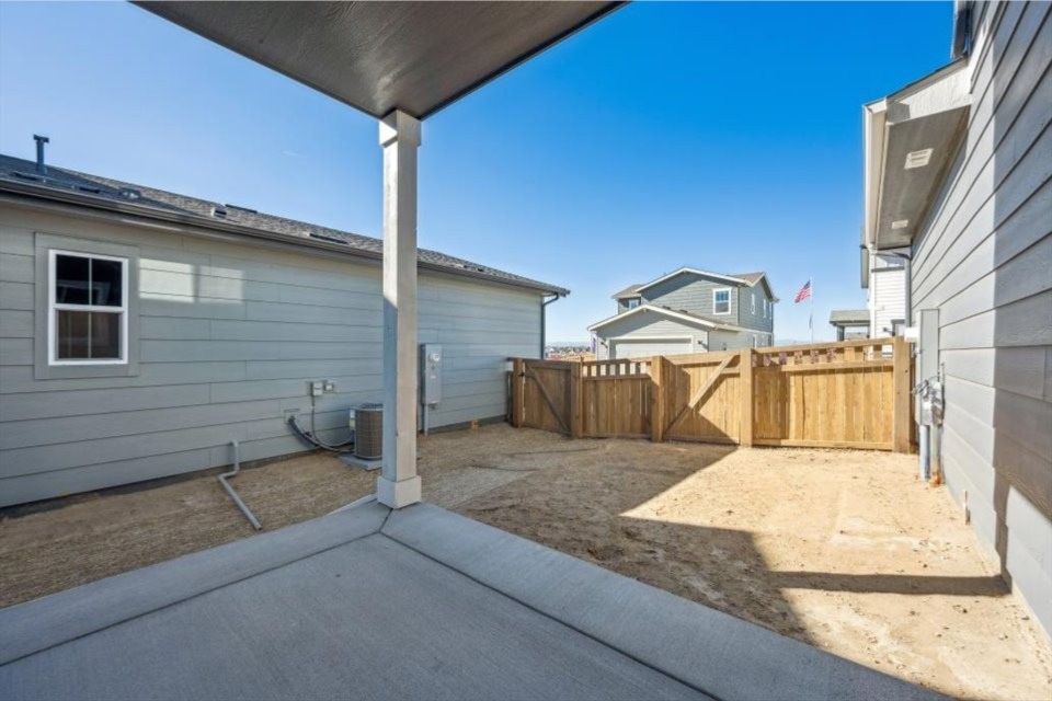 A fenced in area with a building in the background.