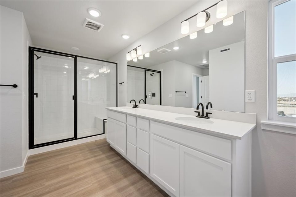 A bathroom with a large mirror.