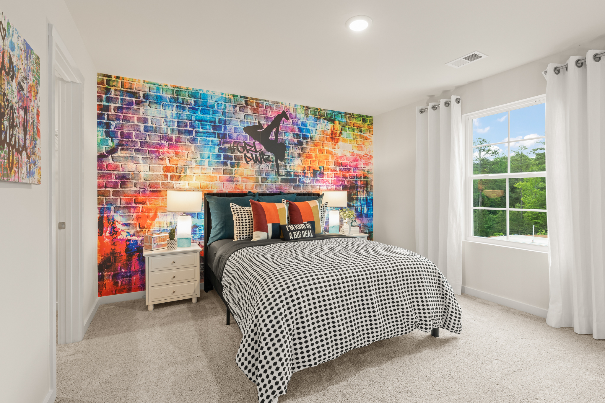 A bedroom with a bed and a window.