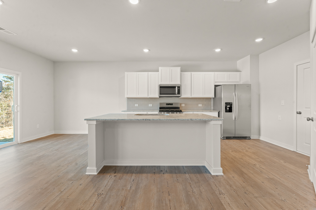 A kitchen with white cabinets.