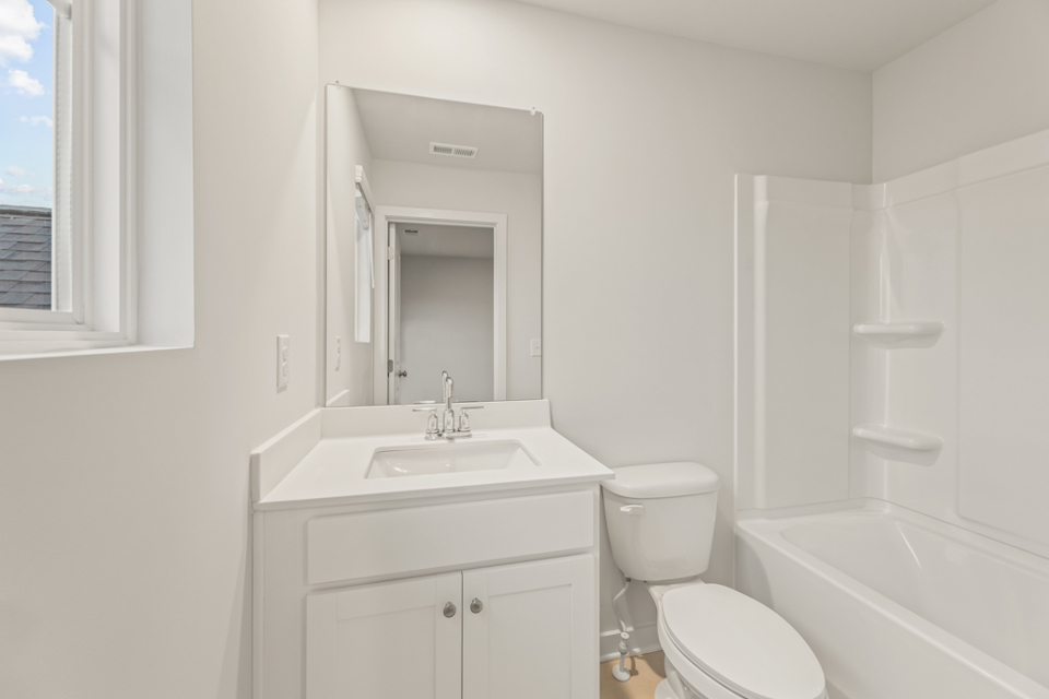 A bathroom with a sink toilet and bathtub.