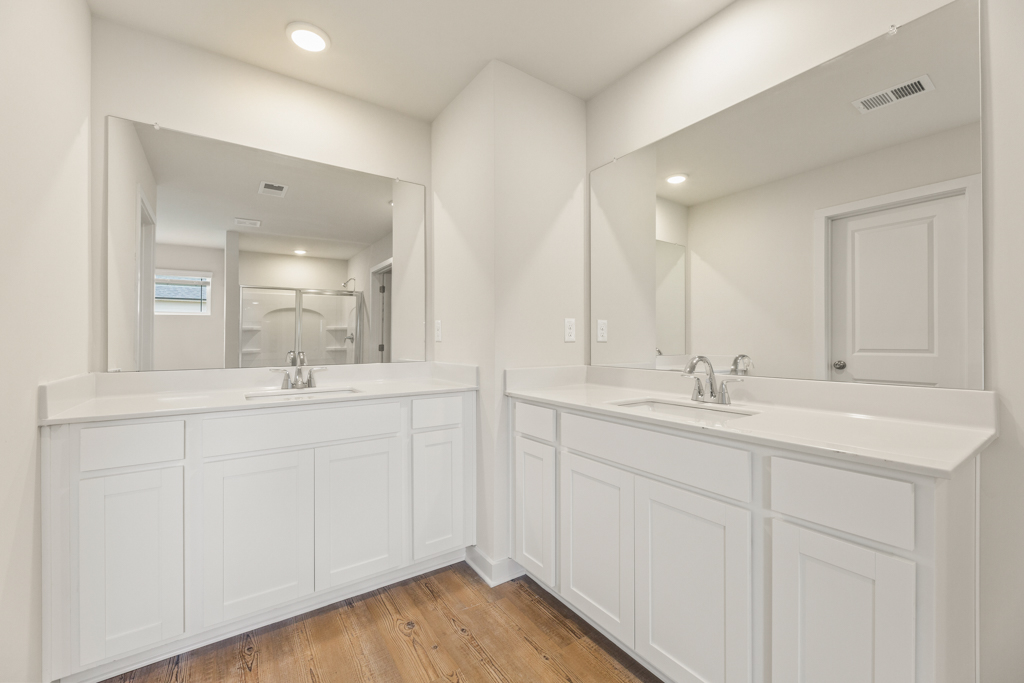A bathroom with white cabinets.