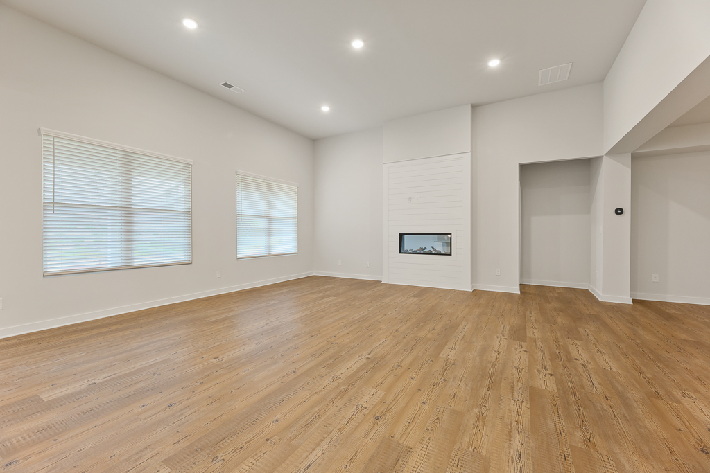 A room with a wood floor and white walls.