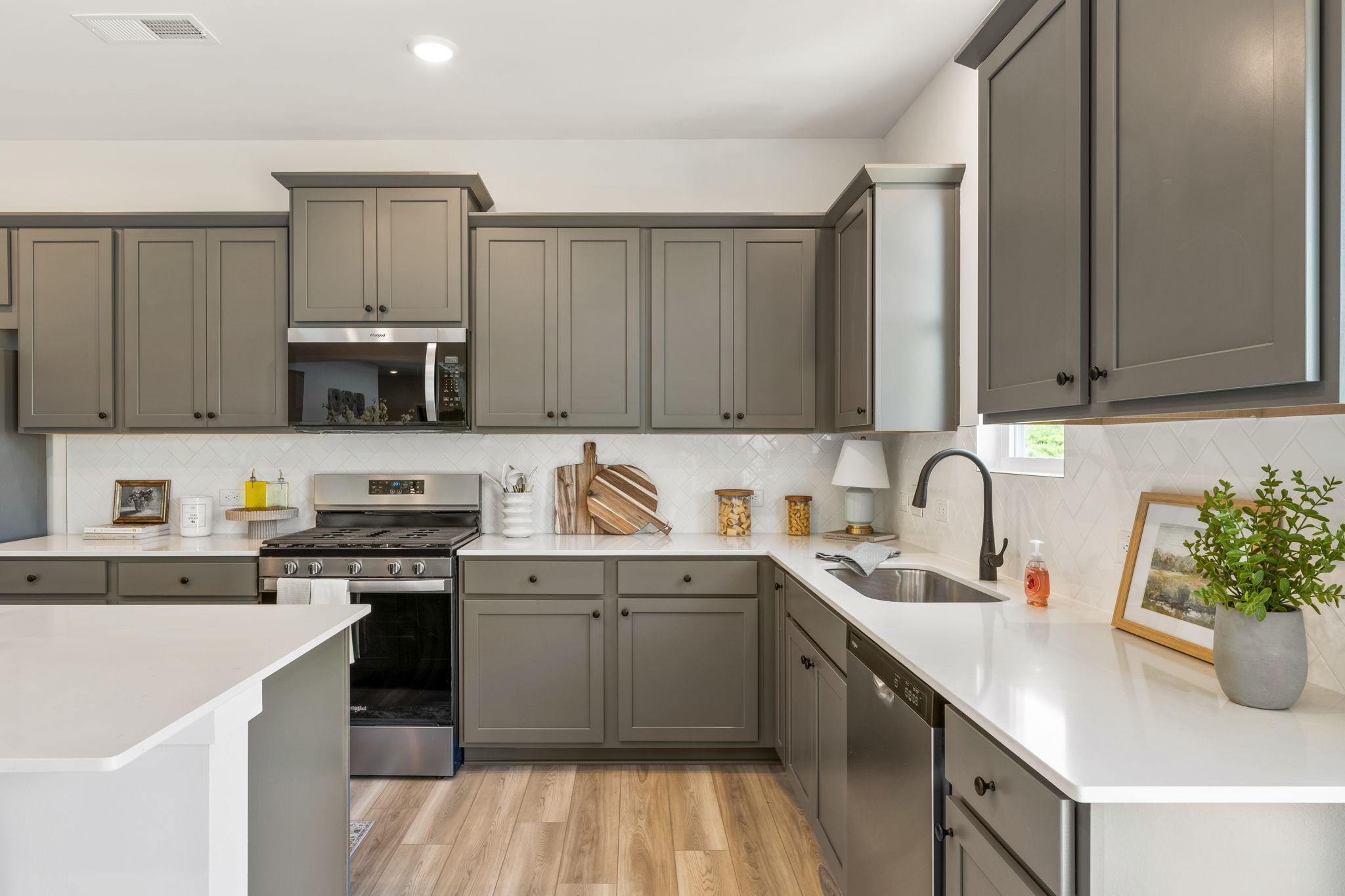 A kitchen with white cabinets.