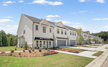 A large white house with a lawn.