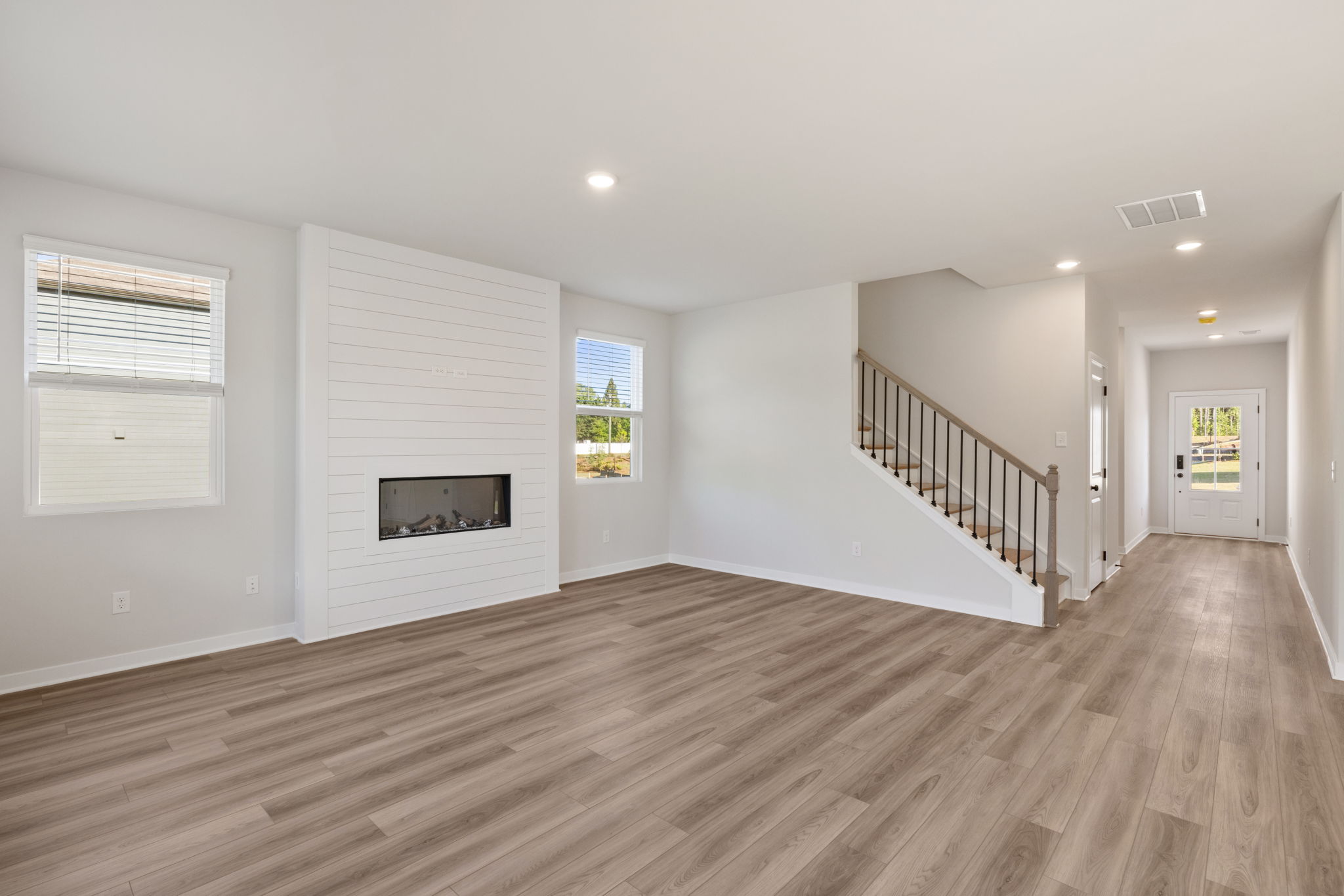 A room with a wood floor and white walls.