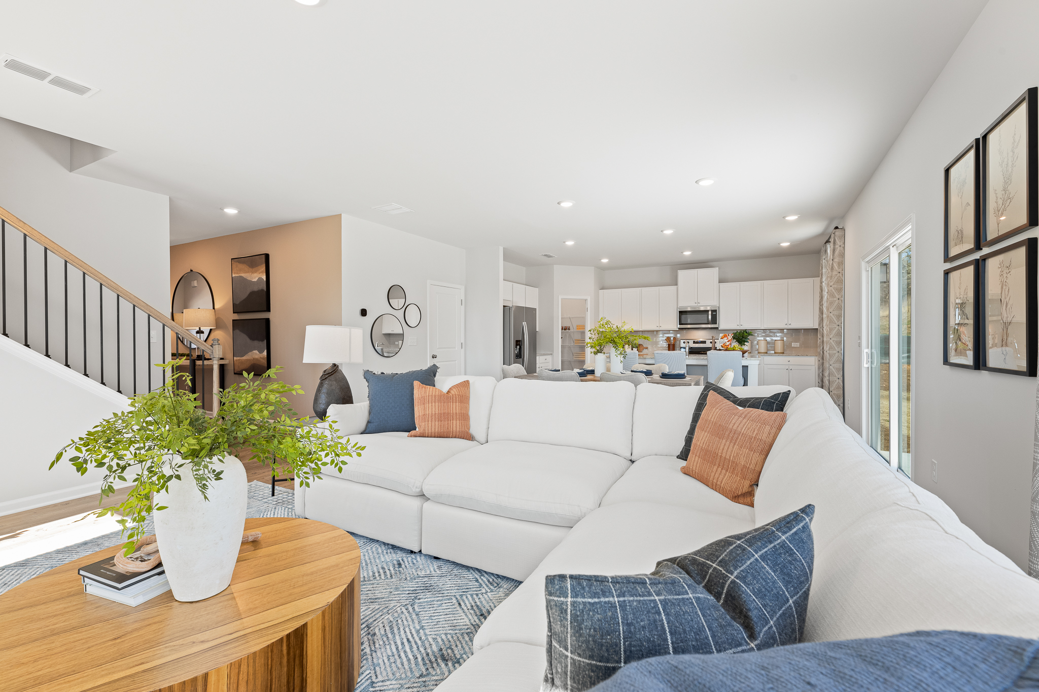 A living room with a white couch and a table.
