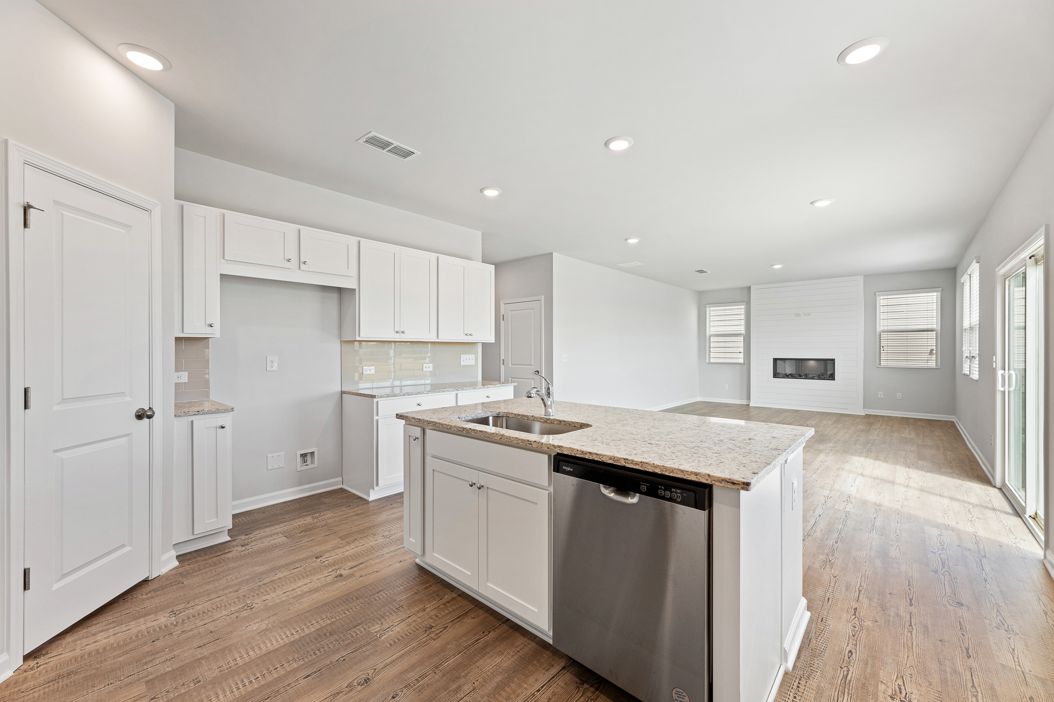 A kitchen with white cabinets.