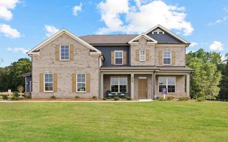 A large house with a lawn in front of it.
