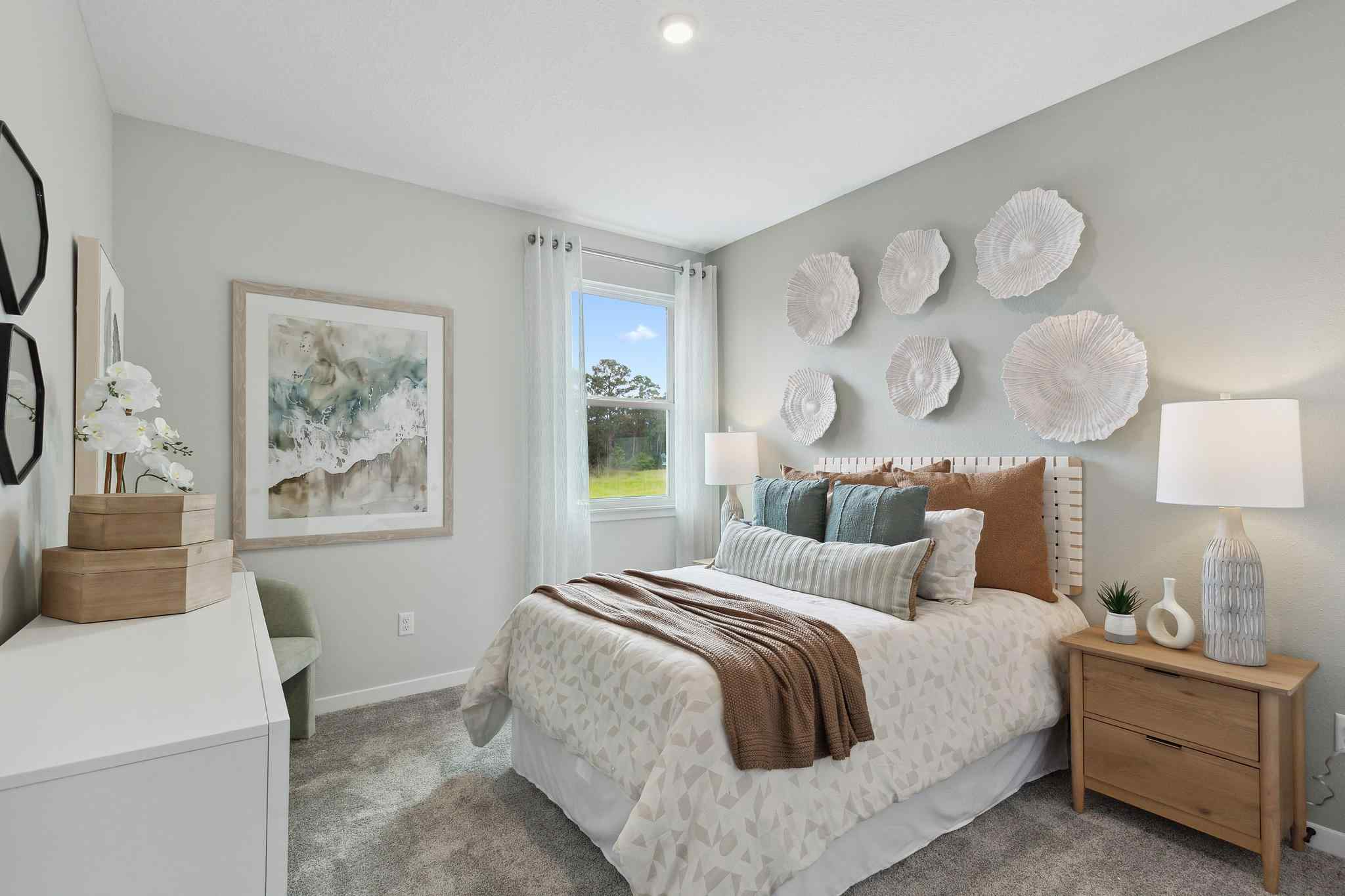 A bedroom with a bed and a window.