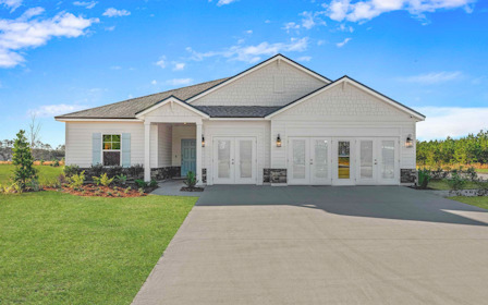 A white house with a driveway.