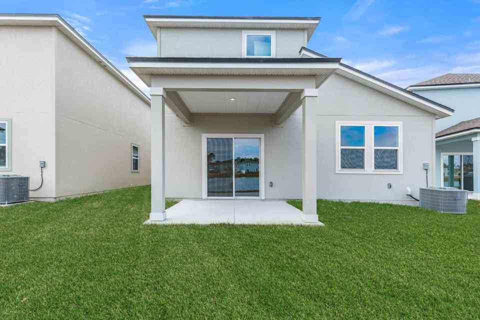 A house with a lawn in front of it.
