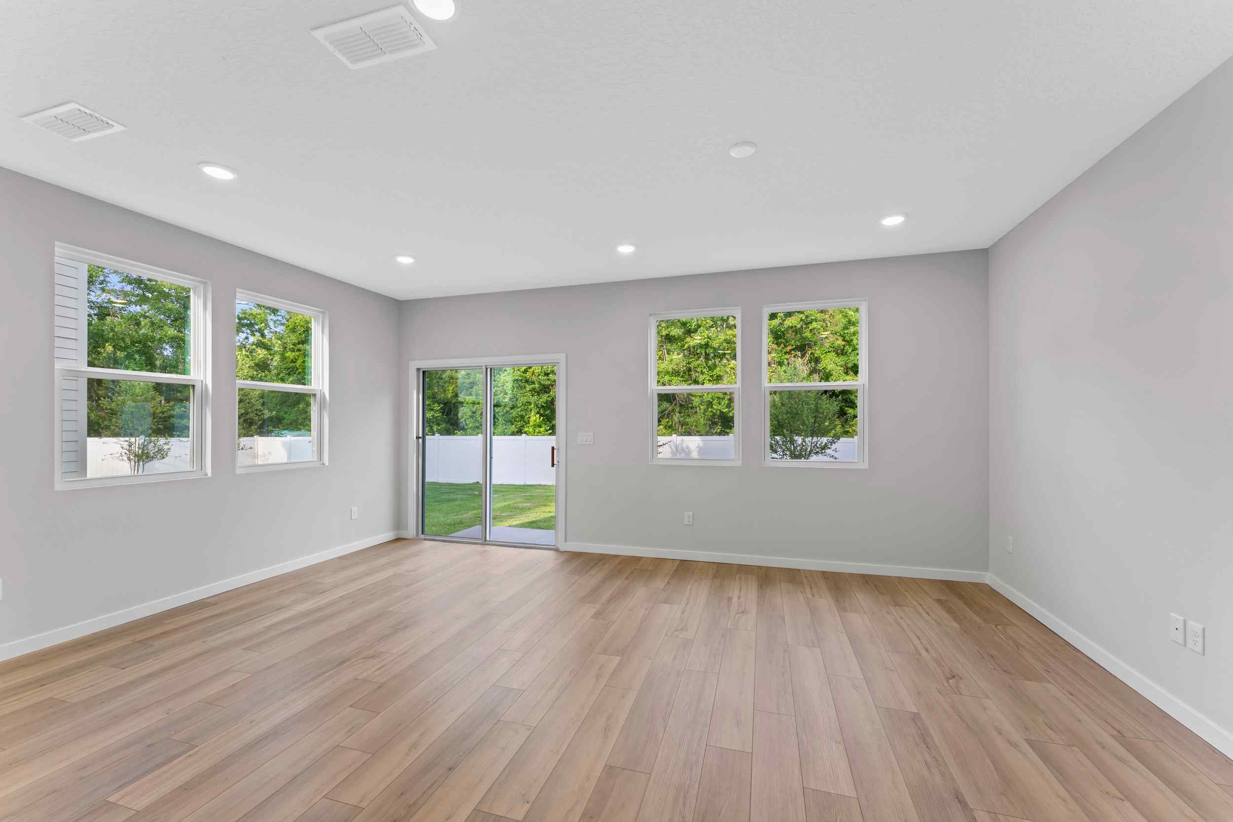 Davor Paired Home Great Room with LVP Floors and Windows at The Landings at Pecan Park in Jacksonville