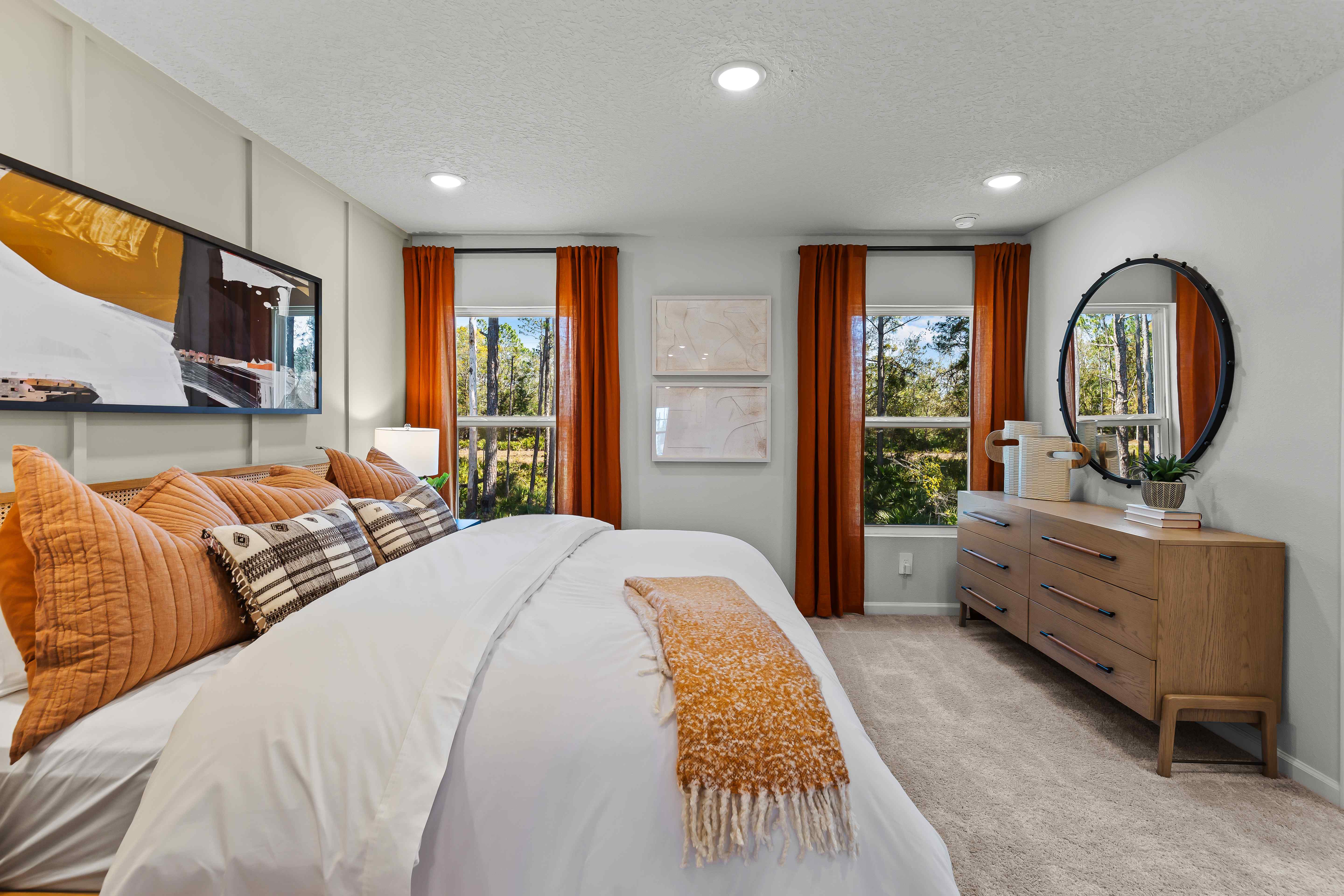 Davor Model Paired Home Primary Bedroom with Bed, Dresser, and 2 Windows at The Landings at Pecan Park